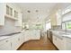 Bright kitchen with white cabinets, a central island, stainless steel appliances, and modern lighting at 2800 Charleston Oaks Dr, Raleigh, NC 27614