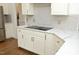 Modern kitchen featuring white cabinets, a stylish backsplash, and granite countertops and stainless steel appliances at 2800 Charleston Oaks Dr, Raleigh, NC 27614