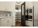 Kitchen boasts a walk-in pantry, stainless steel appliances, and white cabinetry for storage at 2800 Charleston Oaks Dr, Raleigh, NC 27614