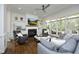 Cozy living room featuring a fireplace, built-in shelving, and a large window at 2800 Charleston Oaks Dr, Raleigh, NC 27614
