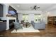 Bright living room with hardwood floors, fireplace, TV, and access to outdoor spaces at 2800 Charleston Oaks Dr, Raleigh, NC 27614