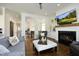 Open-concept living room with fireplace, built-ins, and seamless flow to other areas at 2800 Charleston Oaks Dr, Raleigh, NC 27614