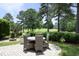 Outdoor patio with comfortable seating, perfect for enjoying the landscaped backyard and golf course views at 2800 Charleston Oaks Dr, Raleigh, NC 27614