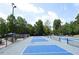 Enjoy this community tennis courts surrounded by mature trees and manicured landscaping on a sunny day at 2800 Charleston Oaks Dr, Raleigh, NC 27614