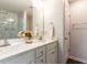 Bright bathroom with a double vanity, framed mirror, and a marble-tiled shower at 286 Beaver Tavern Dr, Benson, NC 27504