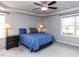Comfortable bedroom featuring a tray ceiling, ceiling fan, and natural light at 286 Beaver Tavern Dr, Benson, NC 27504
