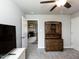 Bedroom showing closet, ceiling fan, and door to living room with fireplace at 286 Beaver Tavern Dr, Benson, NC 27504