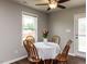 The dining room with wooden table and chairs sits next to a window and exterior door at 286 Beaver Tavern Dr, Benson, NC 27504