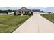 Lovely home showcasing the well-maintained lawn and a long driveway to the garage at 286 Beaver Tavern Dr, Benson, NC 27504