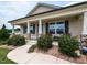 Inviting front porch with stone-clad columns and a cozy seating area at 286 Beaver Tavern Dr, Benson, NC 27504