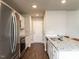 Well-lit kitchen featuring stainless steel appliances, white cabinets, and granite countertops at 286 Beaver Tavern Dr, Benson, NC 27504