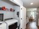 Laundry closet featuring a washer, dryer, and storage shelves, connecting to the dining area at 286 Beaver Tavern Dr, Benson, NC 27504