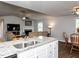 Open living space with a fireplace, ceiling fan, and adjoining dining area at 286 Beaver Tavern Dr, Benson, NC 27504
