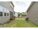 View of the backyard with a grill between the house and a detached garage at 2915 Winter Crop Way, Apex, NC 27502