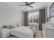 Cozy bedroom featuring a ceiling fan, neutral decor, and a large window for natural light at 2915 Winter Crop Way, Apex, NC 27502