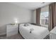 Cozy bedroom featuring a queen bed with a bedside table and window at 2915 Winter Crop Way, Apex, NC 27502