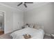 Serene bedroom with a ceiling fan, soft lighting, and minimalist decor for a restful atmosphere at 2915 Winter Crop Way, Apex, NC 27502