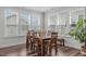 Bright dining room with a large window, wood floors, and stylish table set at 2915 Winter Crop Way, Apex, NC 27502