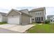 View of the side of the house with a garage and driveway at 2915 Winter Crop Way, Apex, NC 27502