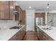 Well-lit kitchen featuring a large island, stainless steel appliances, modern cabinetry, and hardwood floors at 2915 Winter Crop Way, Apex, NC 27502