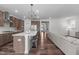 Open-concept kitchen with a large island, stainless steel appliances, and modern pendant lighting at 2915 Winter Crop Way, Apex, NC 27502