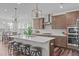 Stylish kitchen features a large island, stainless steel appliances, and pendant lighting, perfect for modern living at 2915 Winter Crop Way, Apex, NC 27502