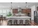 Kitchen featuring a large island with seating and modern lighting fixtures at 2915 Winter Crop Way, Apex, NC 27502