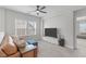 Upstairs living room with neutral decor, a leather couch, and ceiling fan at 2915 Winter Crop Way, Apex, NC 27502