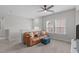 The upstairs living room features neutral colors, a leather couch, and ceiling fan at 2915 Winter Crop Way, Apex, NC 27502