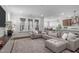 Expansive living room featuring a sectional sofa, hardwood floors, and a seamless flow to the kitchen at 2915 Winter Crop Way, Apex, NC 27502