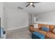 Upstairs living room featuring neutral decor, a leather couch, and a ceiling fan at 2915 Winter Crop Way, Apex, NC 27502