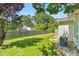 Well-maintained backyard featuring a lush lawn, a classic wooden fence, and mature trees offering ample shade at 3027 Maple Ave # A-1, Burlington, NC 27215