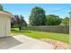 Wide backyard with patio, fence, well-kept lawn, and mature trees for shade and privacy at 3027 Maple Ave # A-1, Burlington, NC 27215