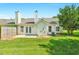 Home's backyard features a stone patio, verdant lawn, two chimneys, and a white exterior at 3027 Maple Ave # A-1, Burlington, NC 27215