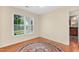 Bedroom featuring hardwood floors, a window for natural light, and a decorative rug at 3027 Maple Ave # A-1, Burlington, NC 27215
