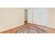An empty bedroom with a closet and hardwood floors, accented by a stylish decorative rug at 3027 Maple Ave # A-1, Burlington, NC 27215