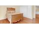 Bedroom featuring wood floors, a wooden bed frame, and a built in closet at 3027 Maple Ave # A-1, Burlington, NC 27215