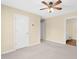 Neutral bedroom featuring a ceiling fan, carpet, and an attached bathroom at 3027 Maple Ave # A-1, Burlington, NC 27215