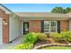 Close-up of the home's brick facade, front door, and landscaped entrance at 3027 Maple Ave # A-1, Burlington, NC 27215