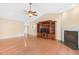 Open-concept living room featuring hardwood floors, fireplace, entertainment center, and a ceiling fan at 3027 Maple Ave # A-1, Burlington, NC 27215