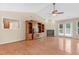 Bright living room featuring hardwood floors, fireplace, ceiling fan, entertainment center, and a glass door at 3027 Maple Ave # A-1, Burlington, NC 27215