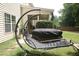 Enjoy the backyard with a covered patio, hot tub, and cozy swing chair at 309 Forest Haven Drive Dr, Holly Springs, NC 27540