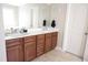 Bright bathroom features dual sinks, spacious countertop, and dark wood cabinetry at 309 Forest Haven Drive Dr, Holly Springs, NC 27540