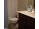 Cozy bathroom featuring a vanity and toilet with leaf-patterned shower curtain at 309 Forest Haven Drive Dr, Holly Springs, NC 27540