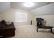 Bonus room offers a sofa, mounted television, and exercise equipment; perfect for recreation, fitness and relaxation at 309 Forest Haven Drive Dr, Holly Springs, NC 27540
