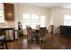 Eat-in kitchen features a dark wood table, four upholstered chairs and a window overlooking the backyard at 309 Forest Haven Drive Dr, Holly Springs, NC 27540