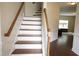 Entryway with hardwood floors, stairs, and trim accents at 309 Forest Haven Drive Dr, Holly Springs, NC 27540