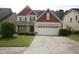Two-story home featuring a two car garage and a well-manicured lawn at 309 Forest Haven Drive Dr, Holly Springs, NC 27540