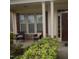Inviting front porch with comfortable seating, columns, and decorative landscaping at 309 Forest Haven Drive Dr, Holly Springs, NC 27540