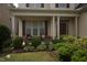 Charming covered front porch with chairs, pillars, and a meticulously landscaped garden at 309 Forest Haven Drive Dr, Holly Springs, NC 27540